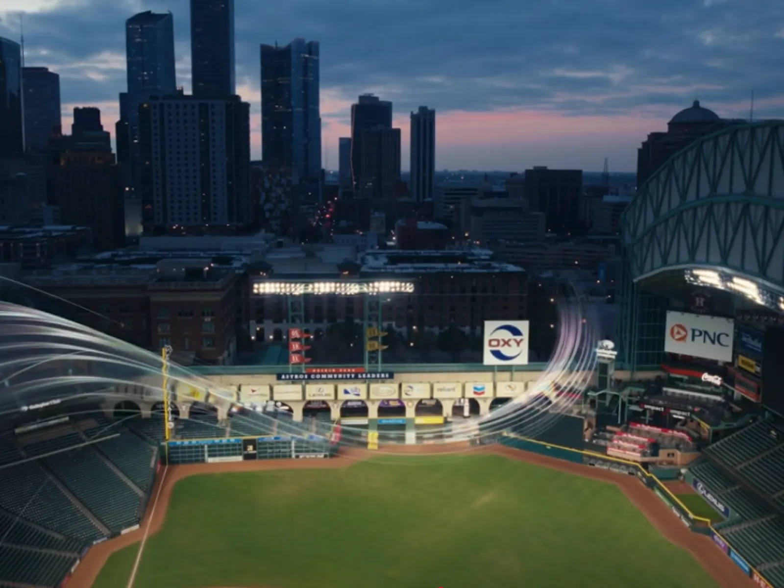Houston skyline at dusk over empty Minute Maid Park with artistic baseball trajectory trails in the air