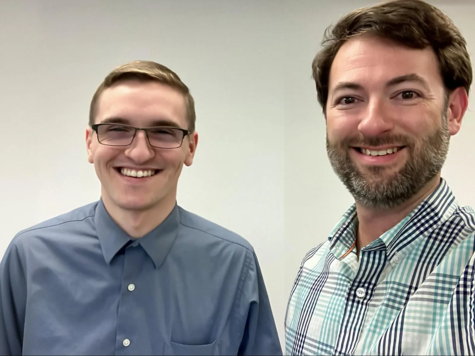 a couple of men smiling