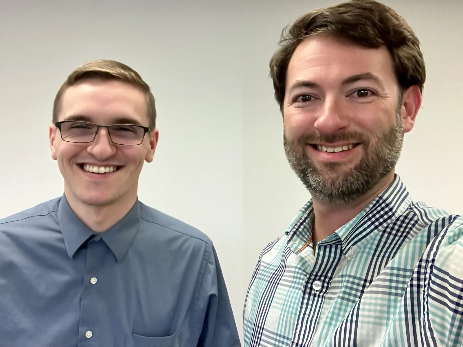 a couple of men smiling