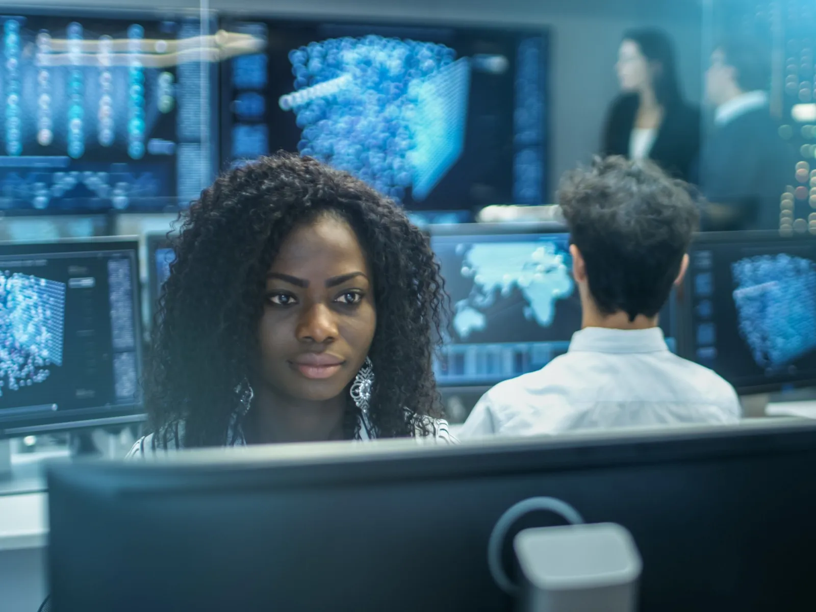 a person sitting in front of a computer screen