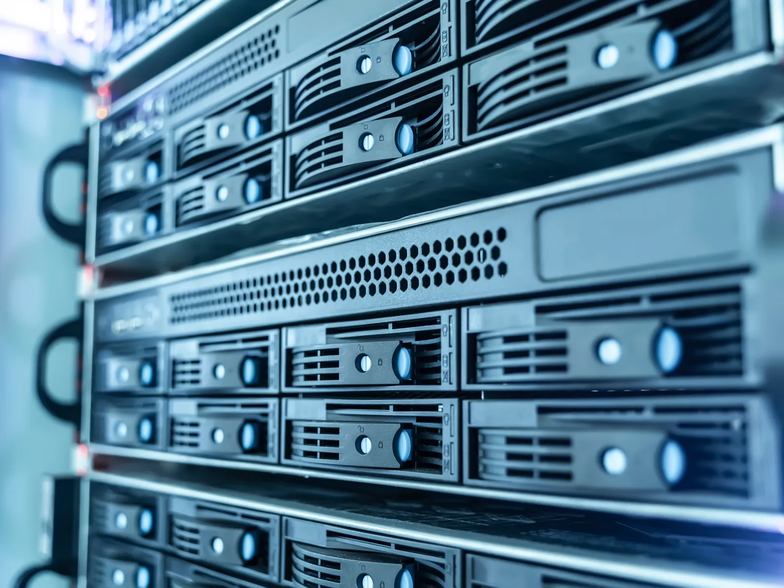 Close-up view of multiple rack-mounted black data servers with cooling vents and indicator lights.