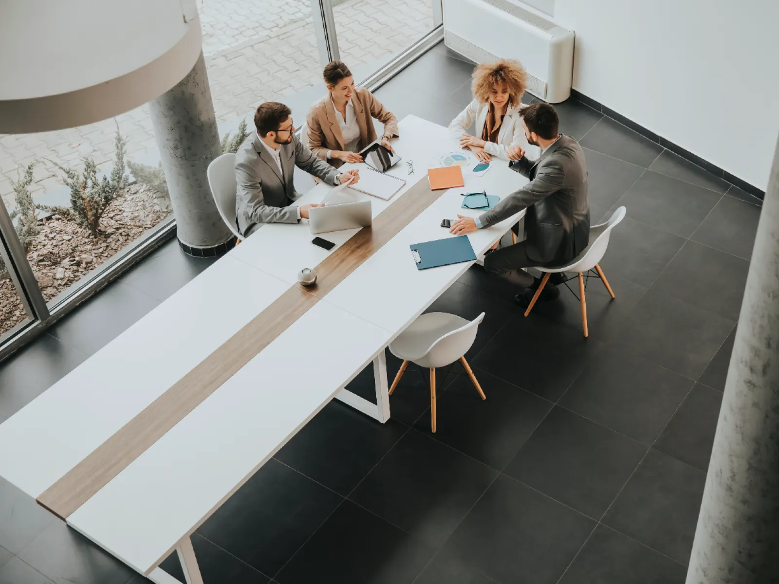 Surveillance system interface showing multiple live camera feeds with highlighted individuals in an indoor building.