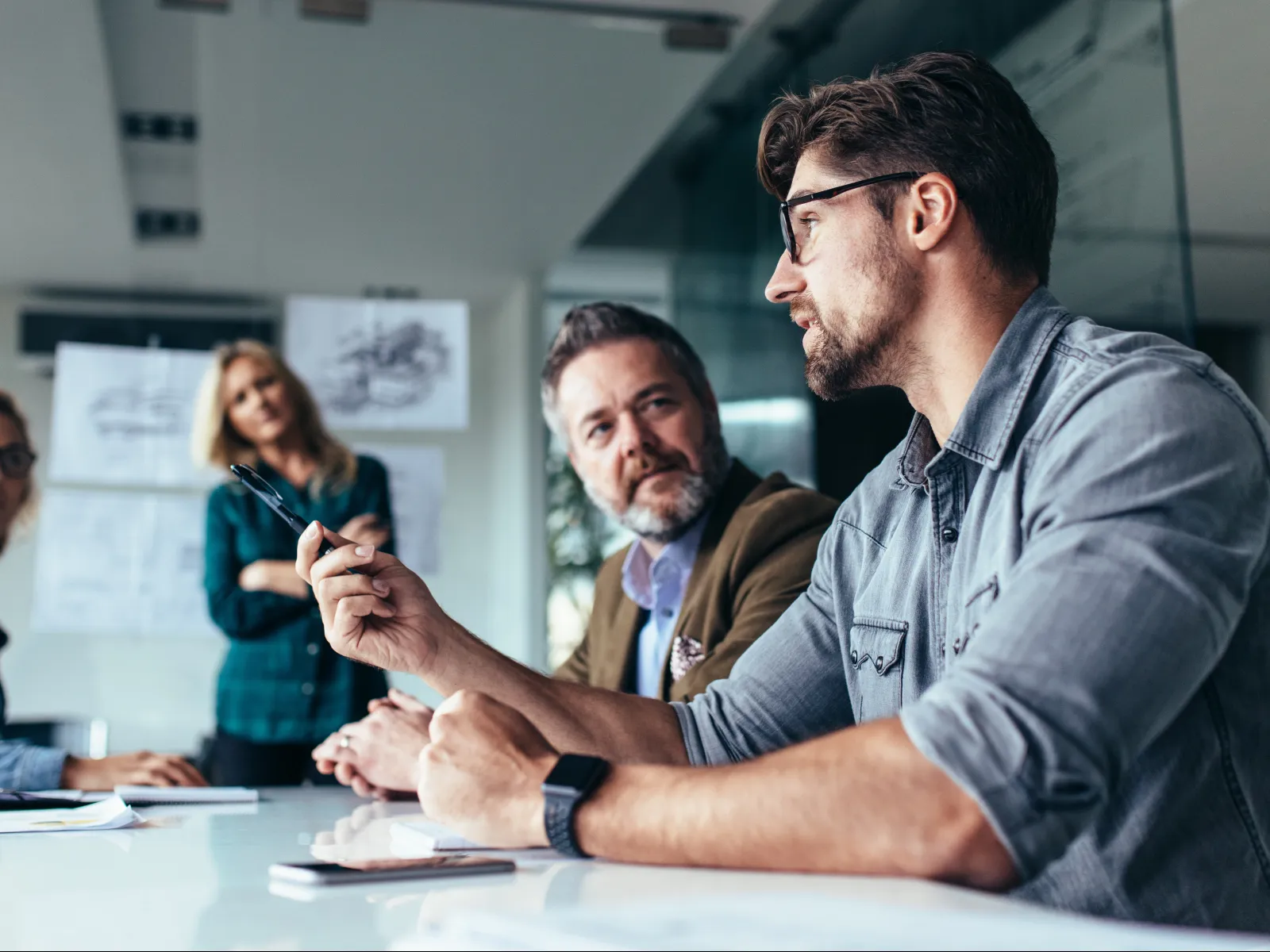 a group of people sitting at a table talking