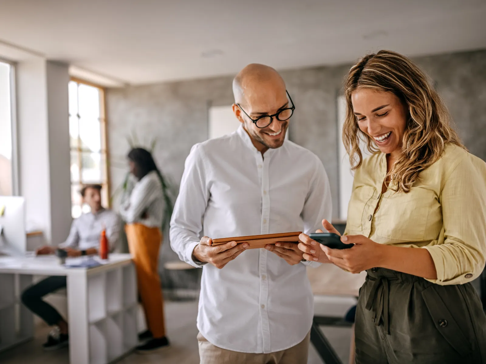 a man and a woman looking at a phone