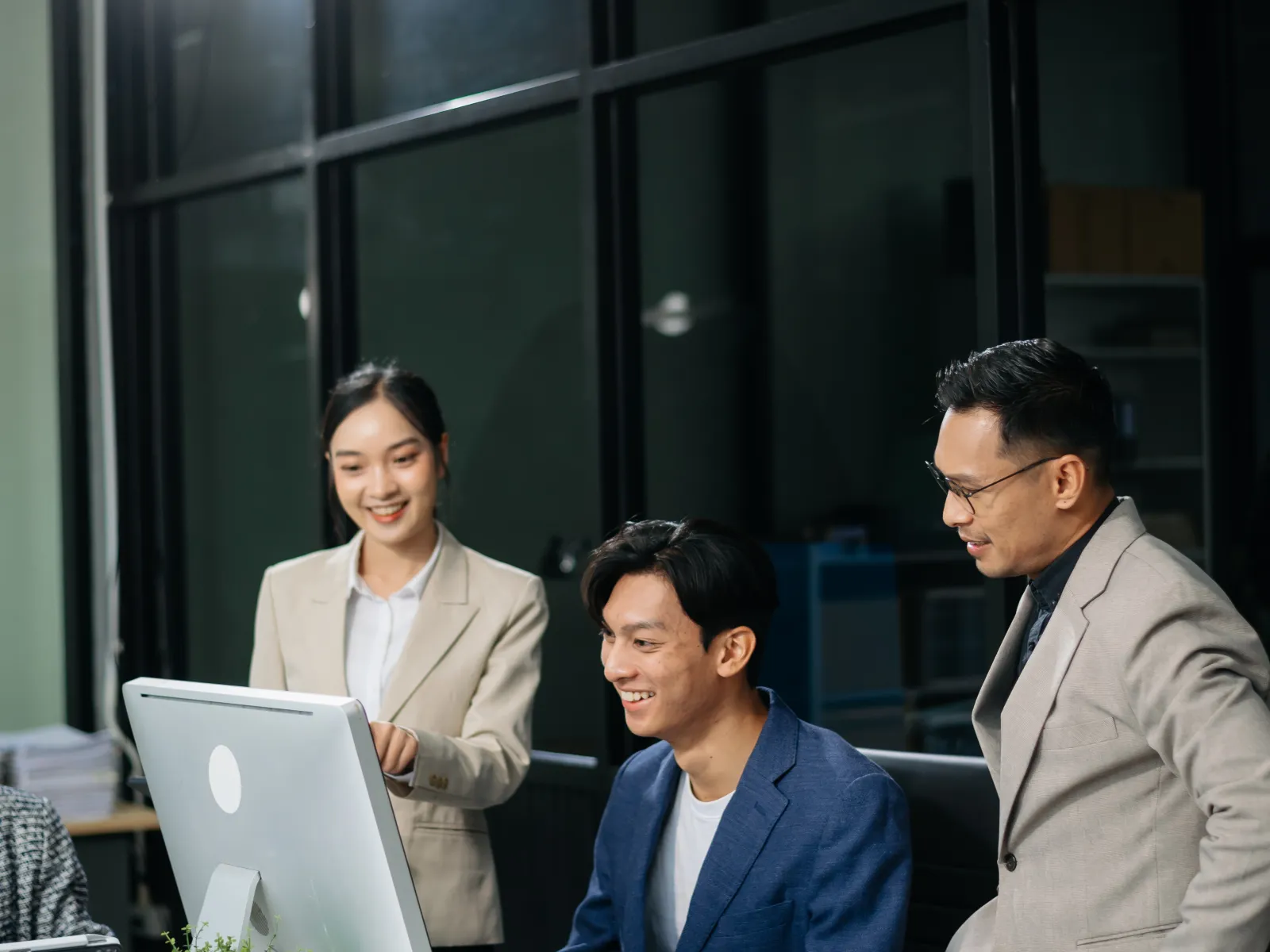 a group of people looking at a laptop