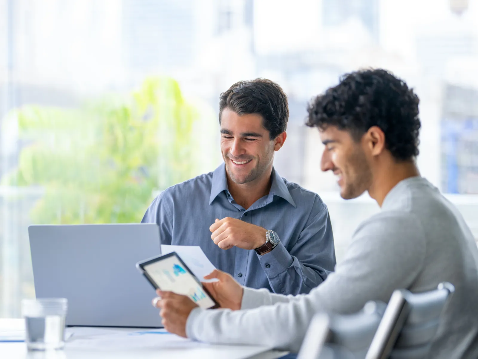 men looking at a laptop