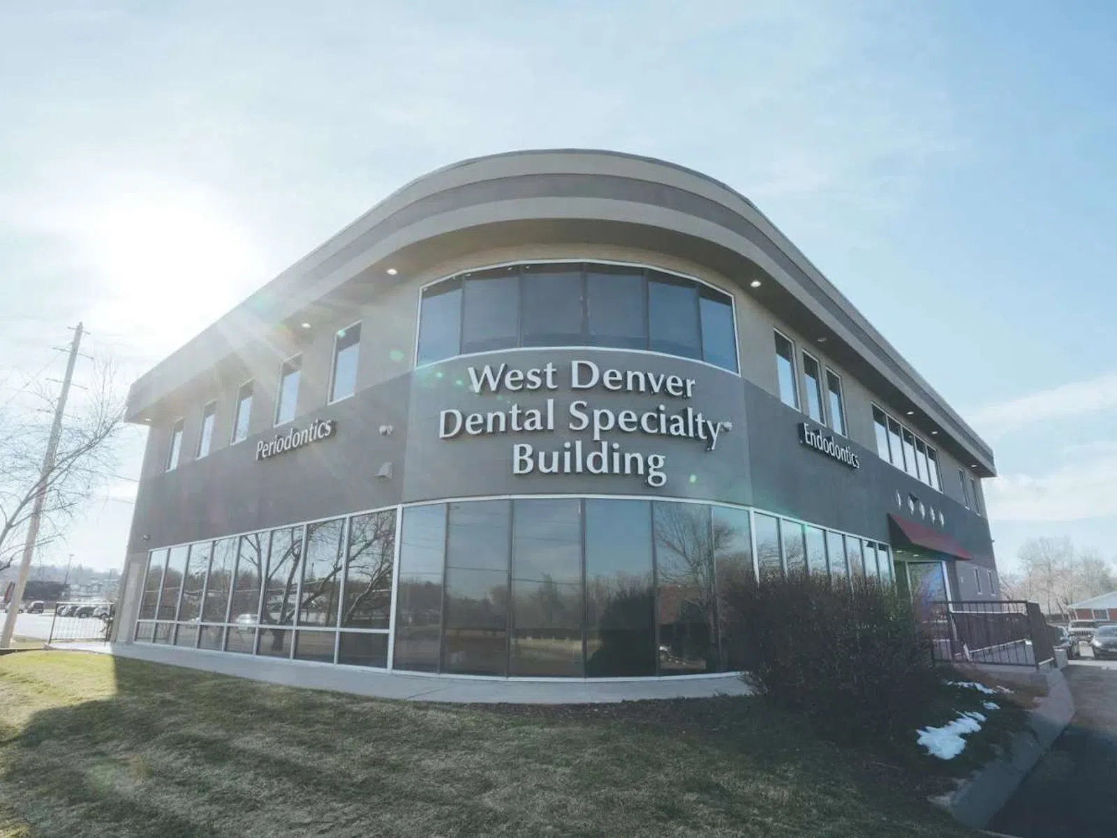 Modern West Denver Dental Specialty Building with large windows and clear blue sky on a sunny day.