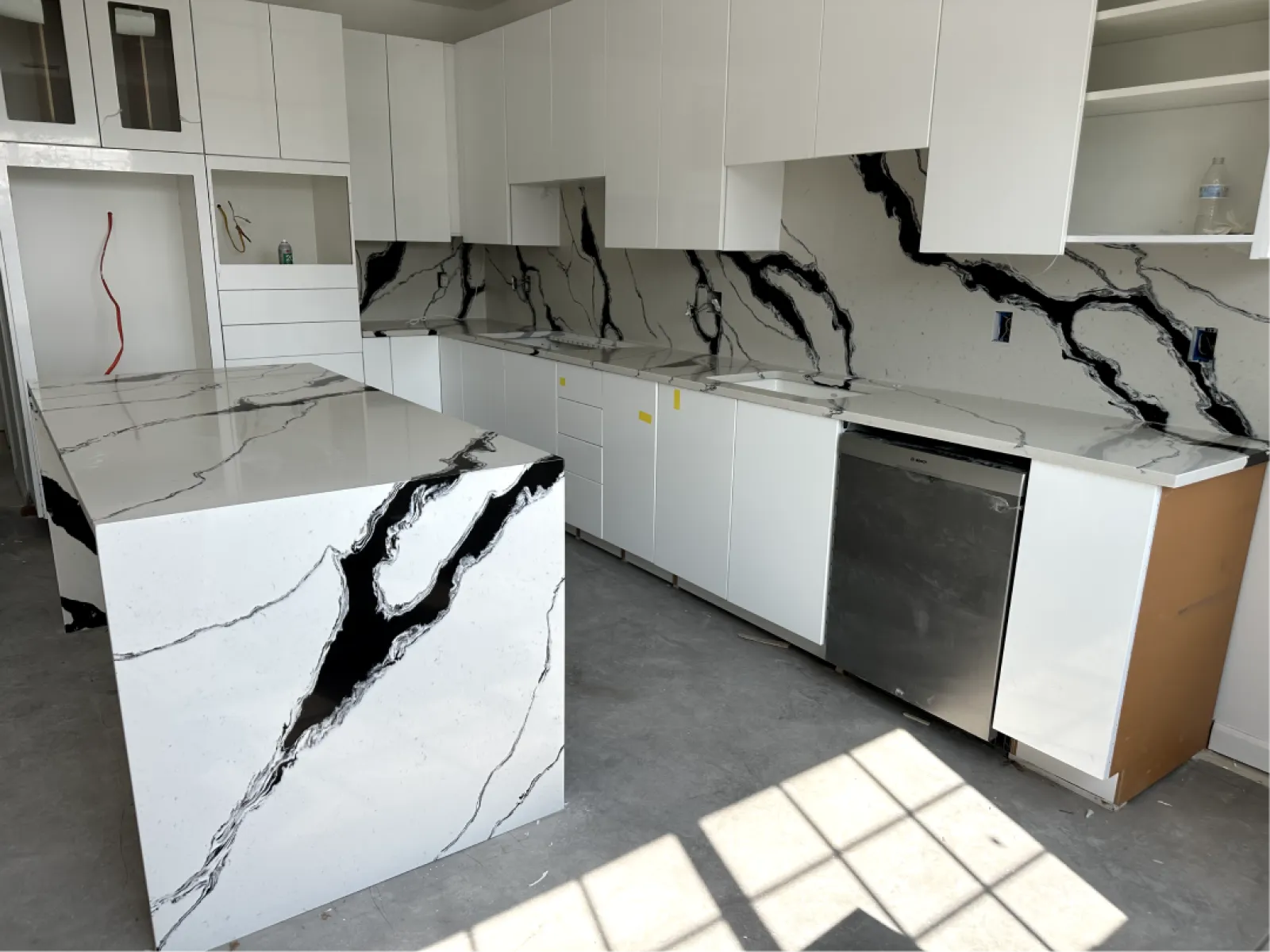 a kitchen with white cabinets