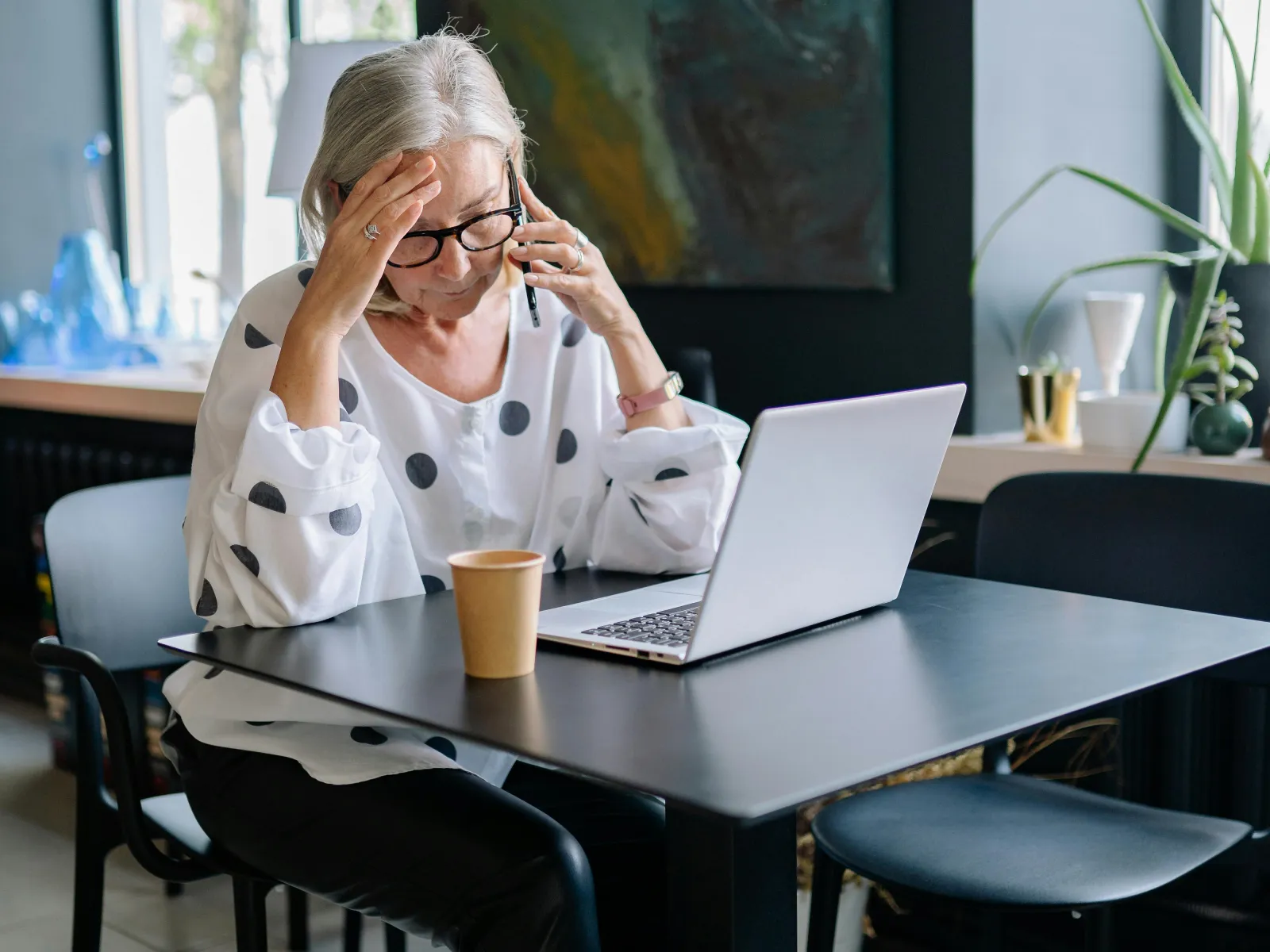 a person sitting at a table with a laptop
