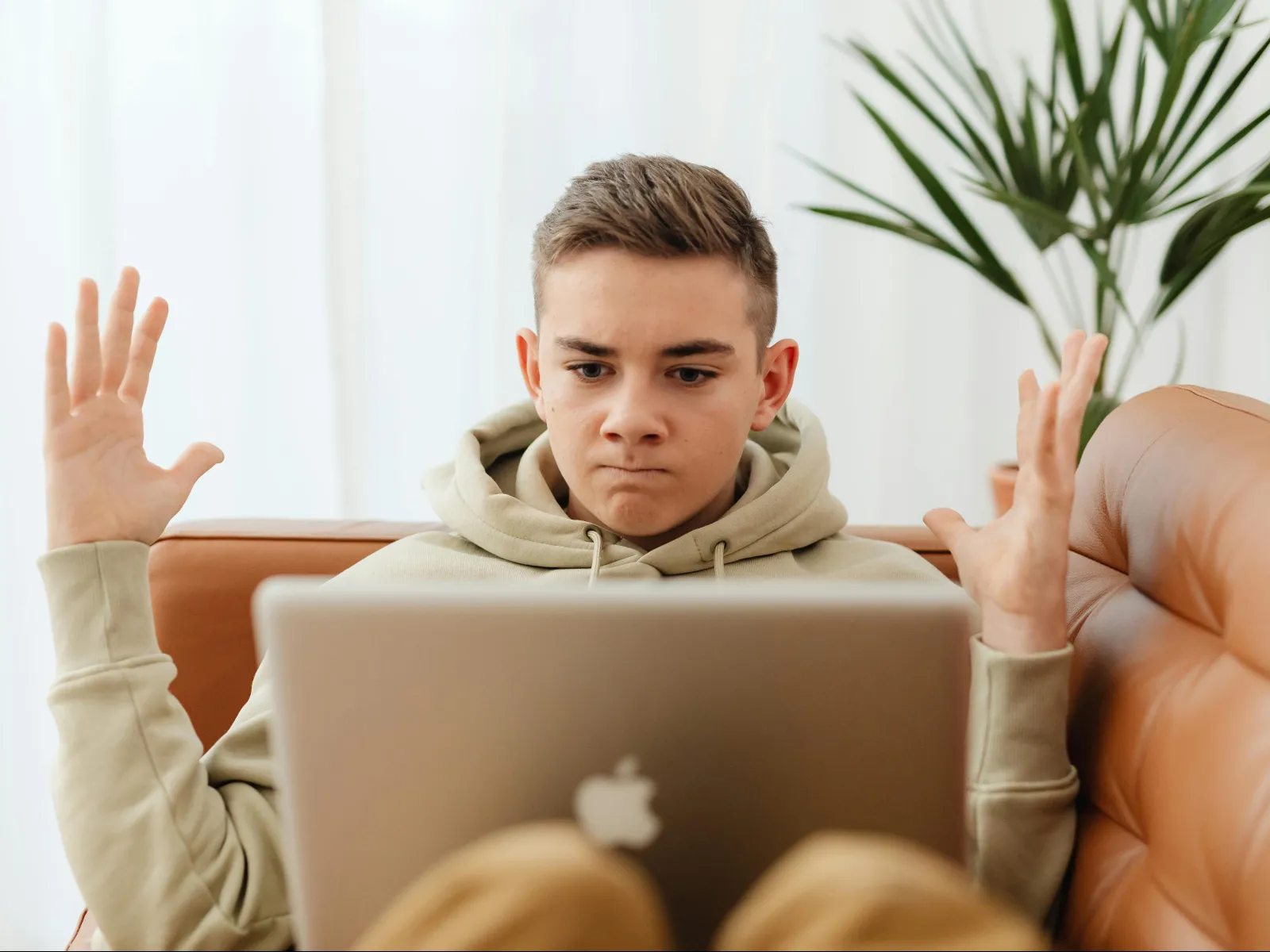 a person sitting on a couch with the hands up