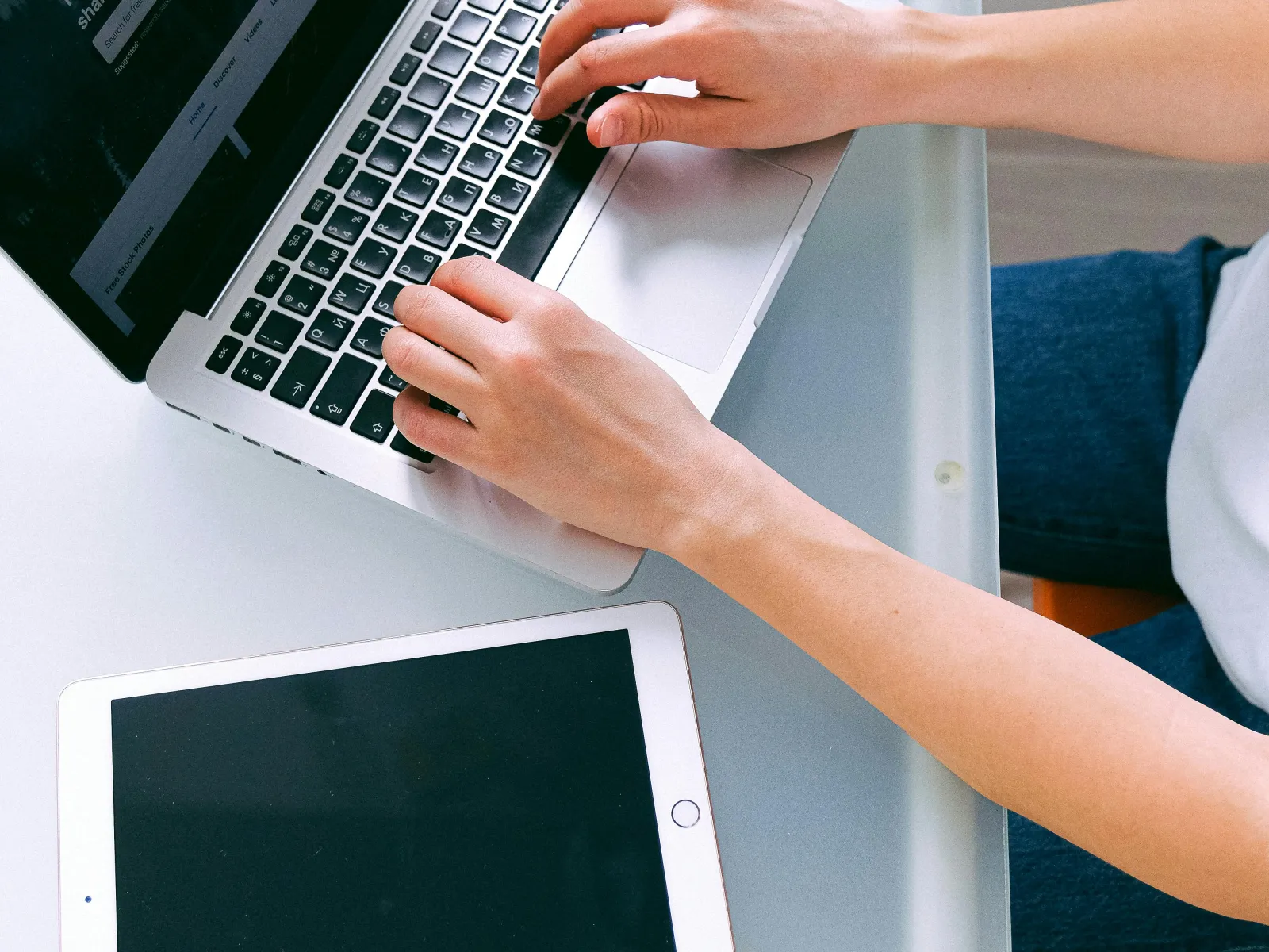 a person typing on a laptop
