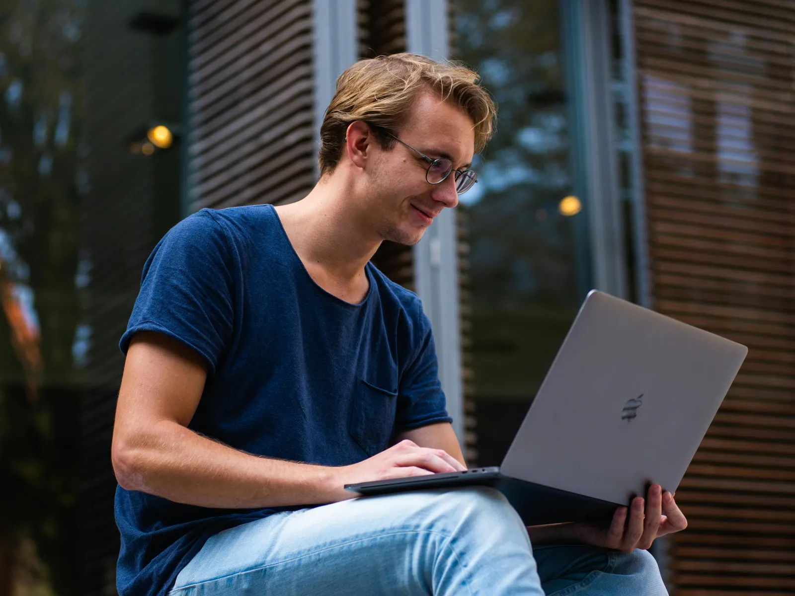 a person sitting outside using a laptop