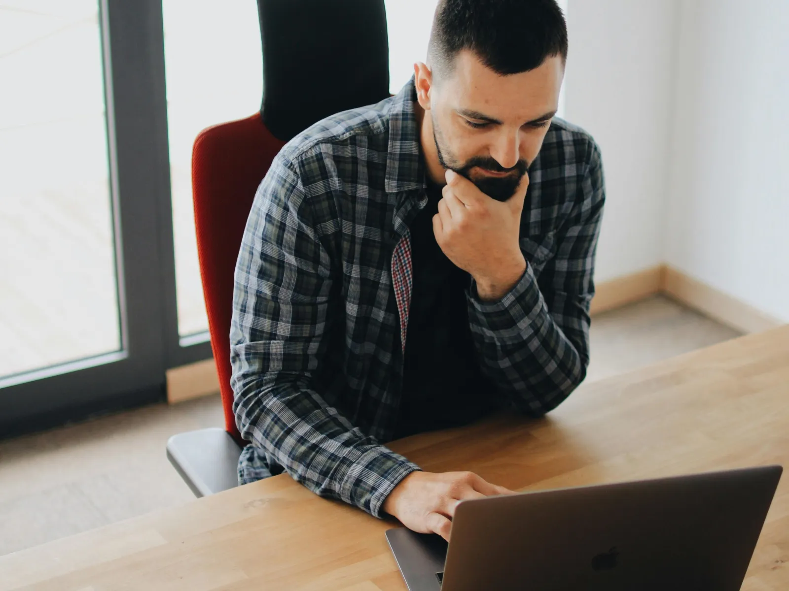 a man sitting at a table with a laptop