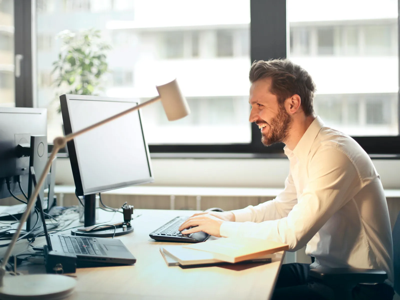 a person sitting at a desk with a computer