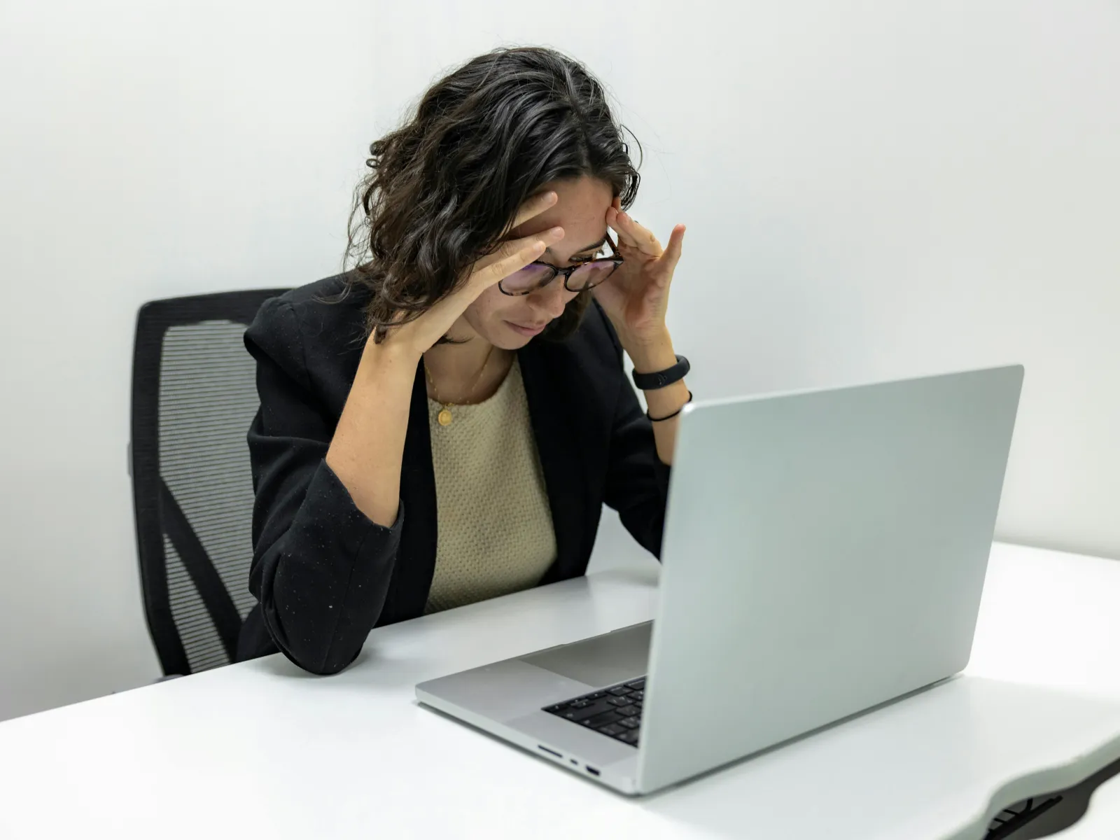 a woman sitting at a table with her hand on her face