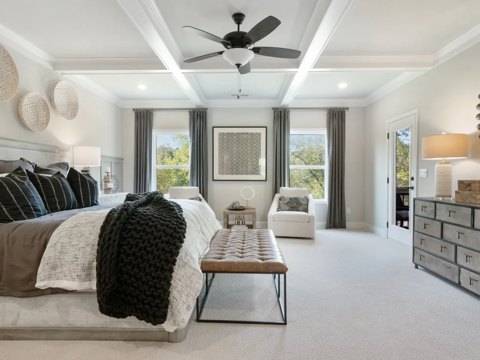a bedroom with a large bed and sitting area