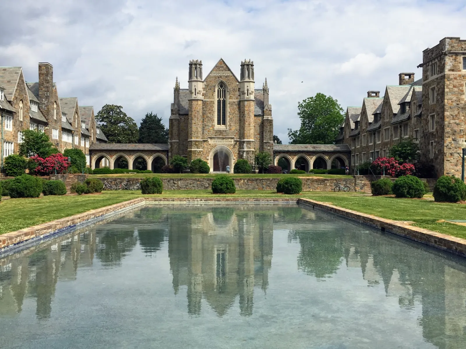 a large castle with a pond in front of it