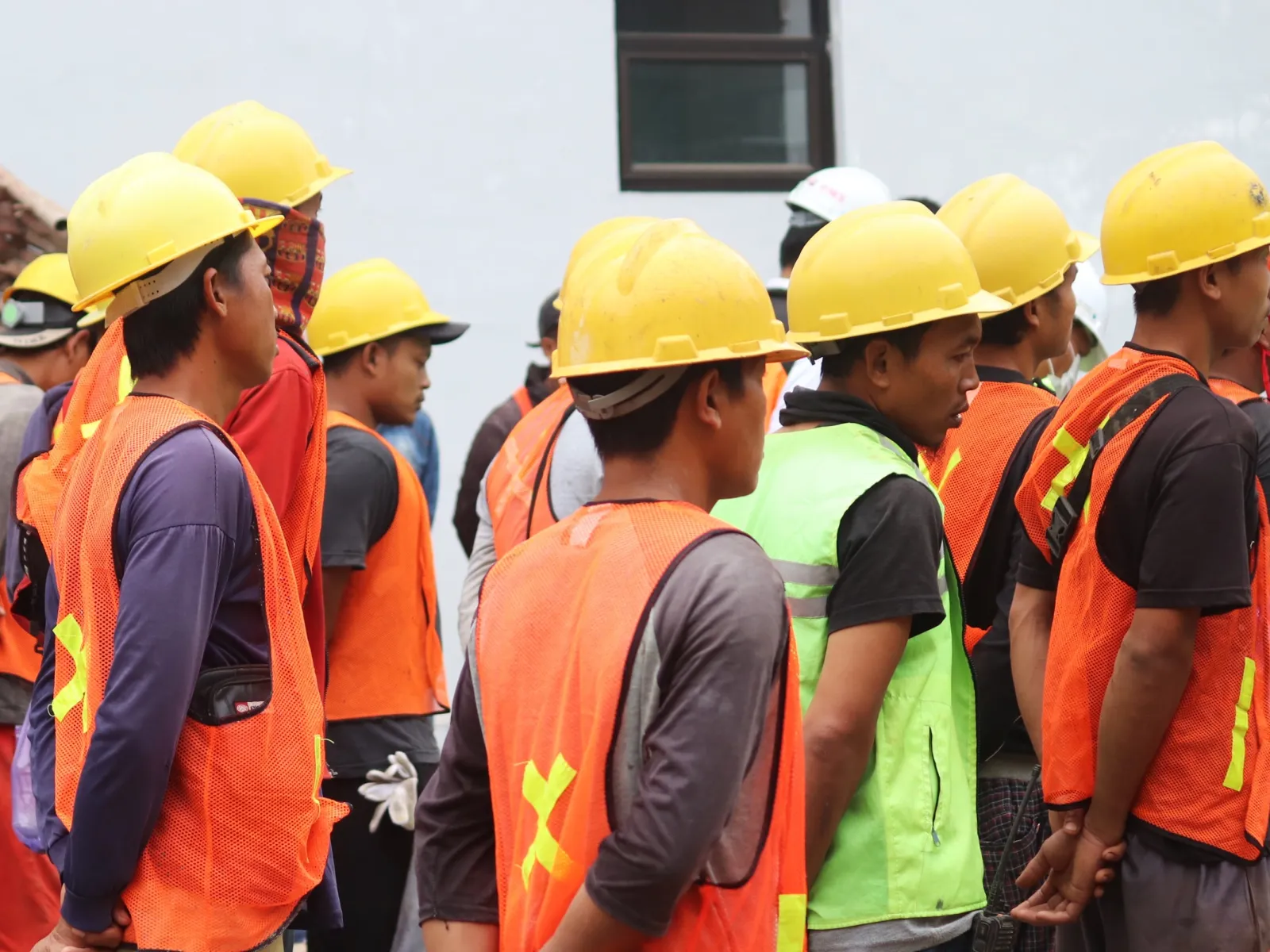 a group of people wearing yellow vests