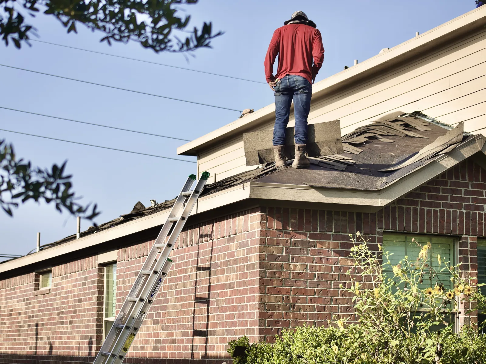 a person on a ladder on a roof