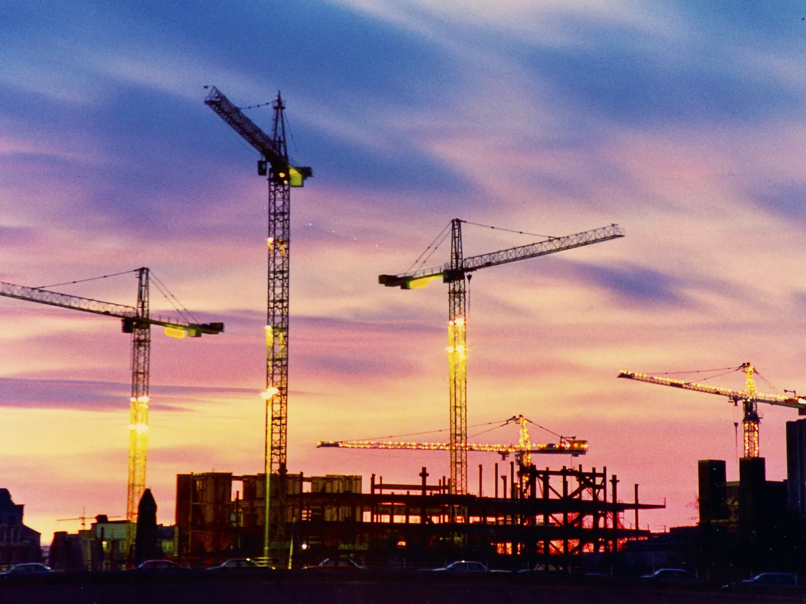 a group of cranes at a construction site