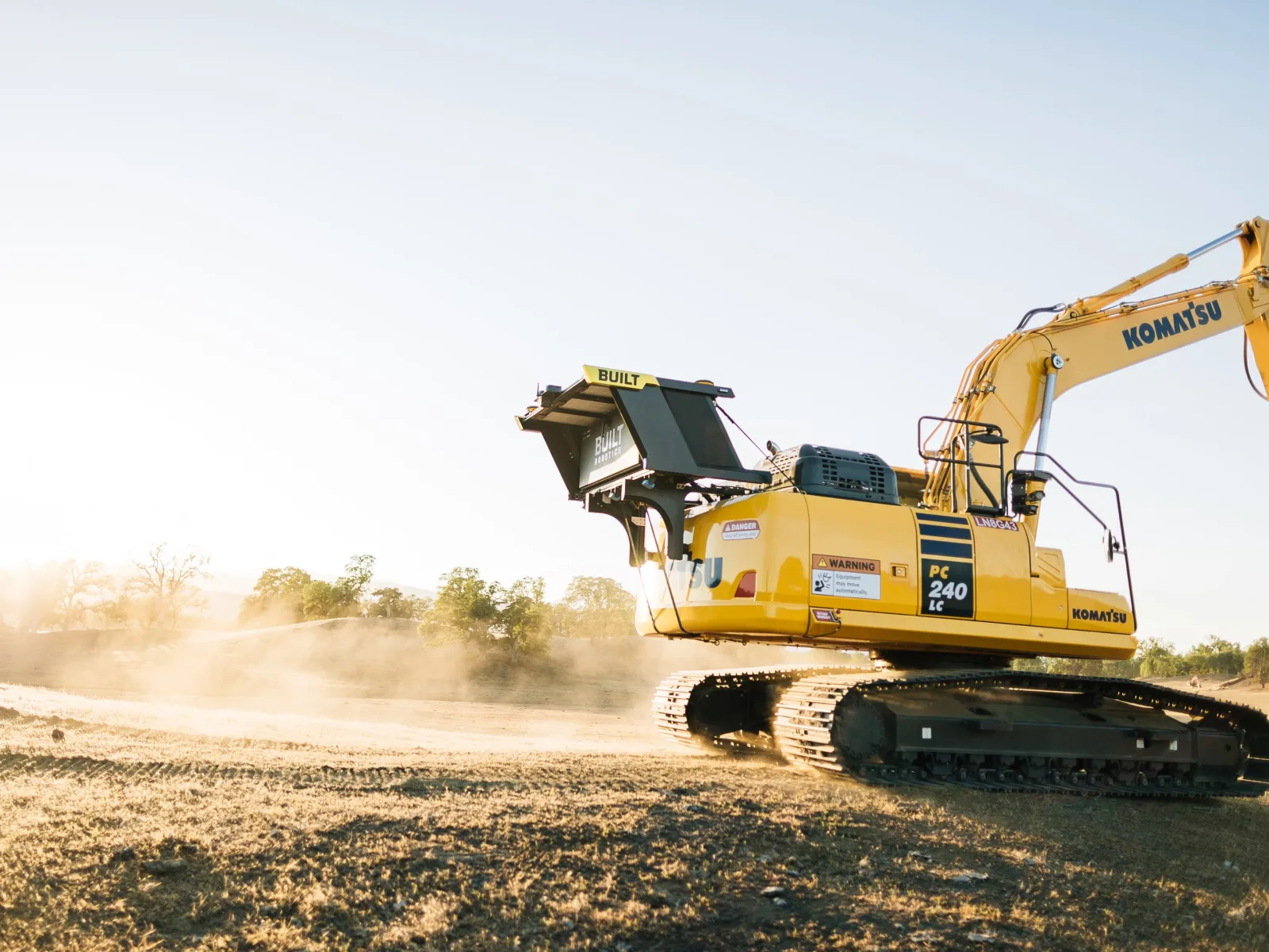 a yellow bulldozer in a field