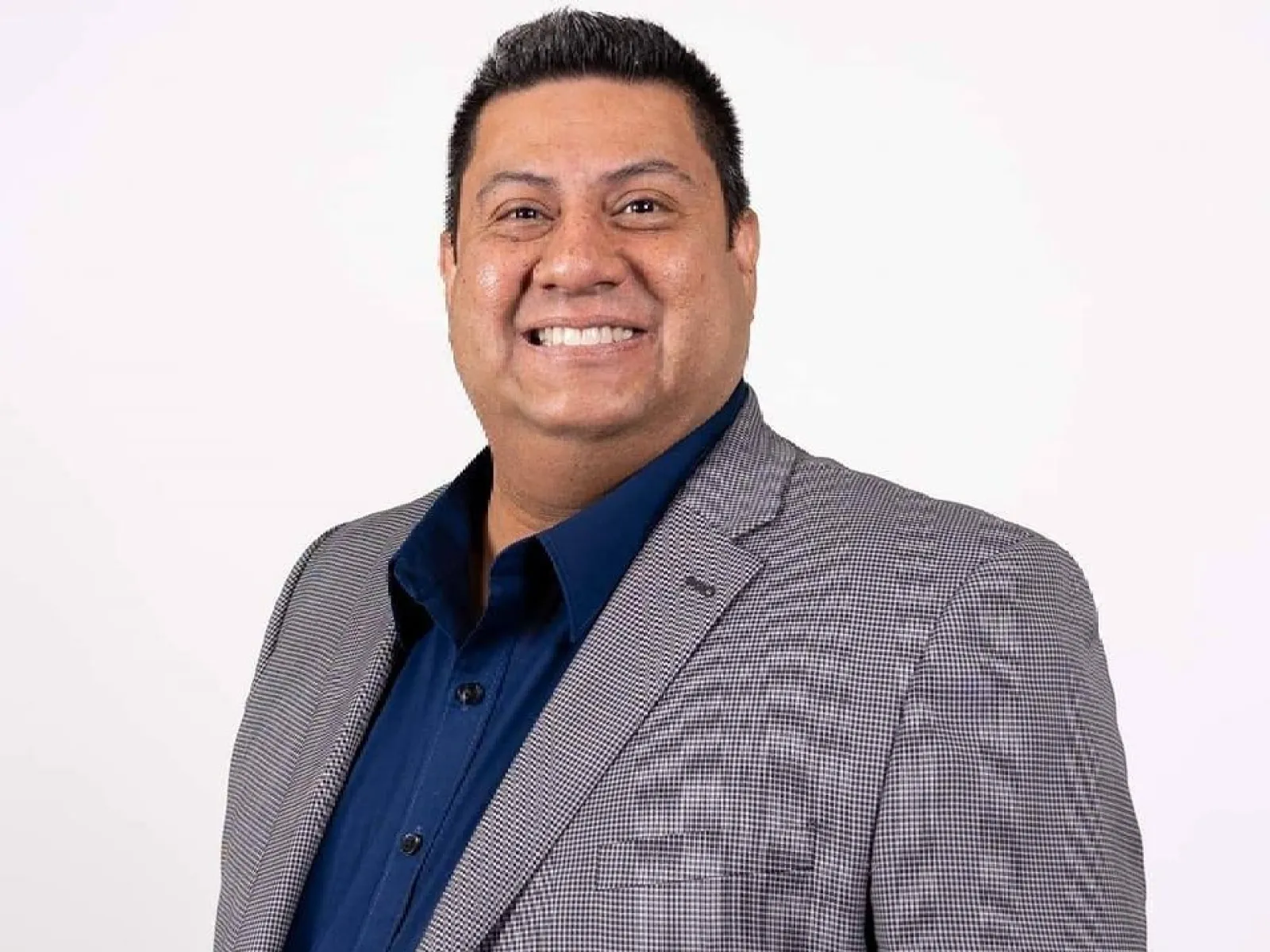 a man in a suit smiling