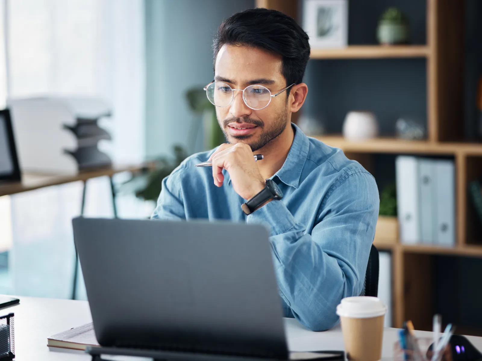 a person sitting at a desk with a laptop