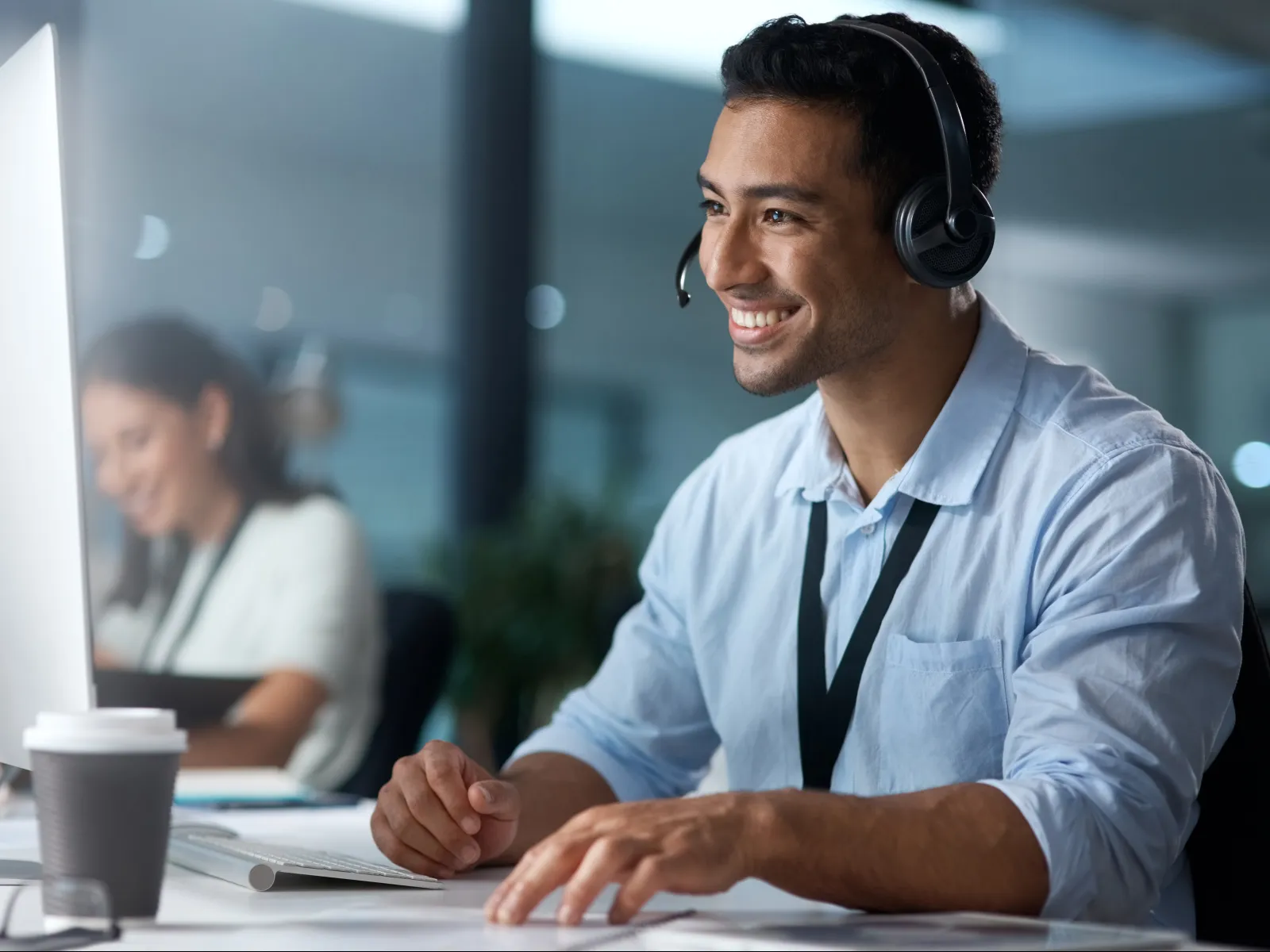 a person wearing headphones and sitting at a desk