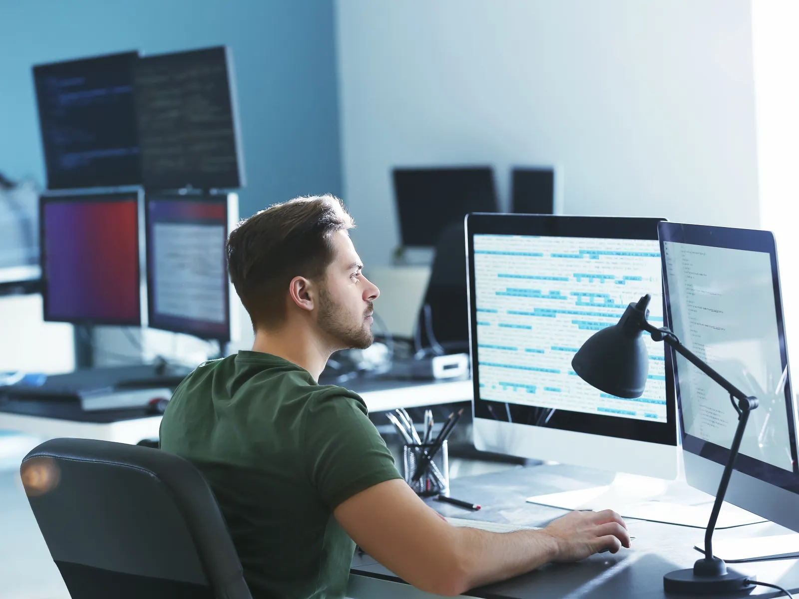 a person sitting at a desk with a computer