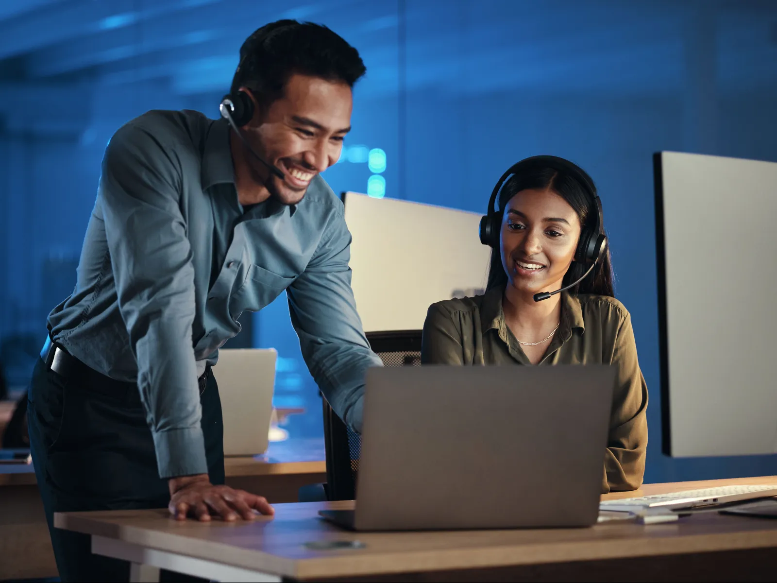 a man and a woman looking at a laptop