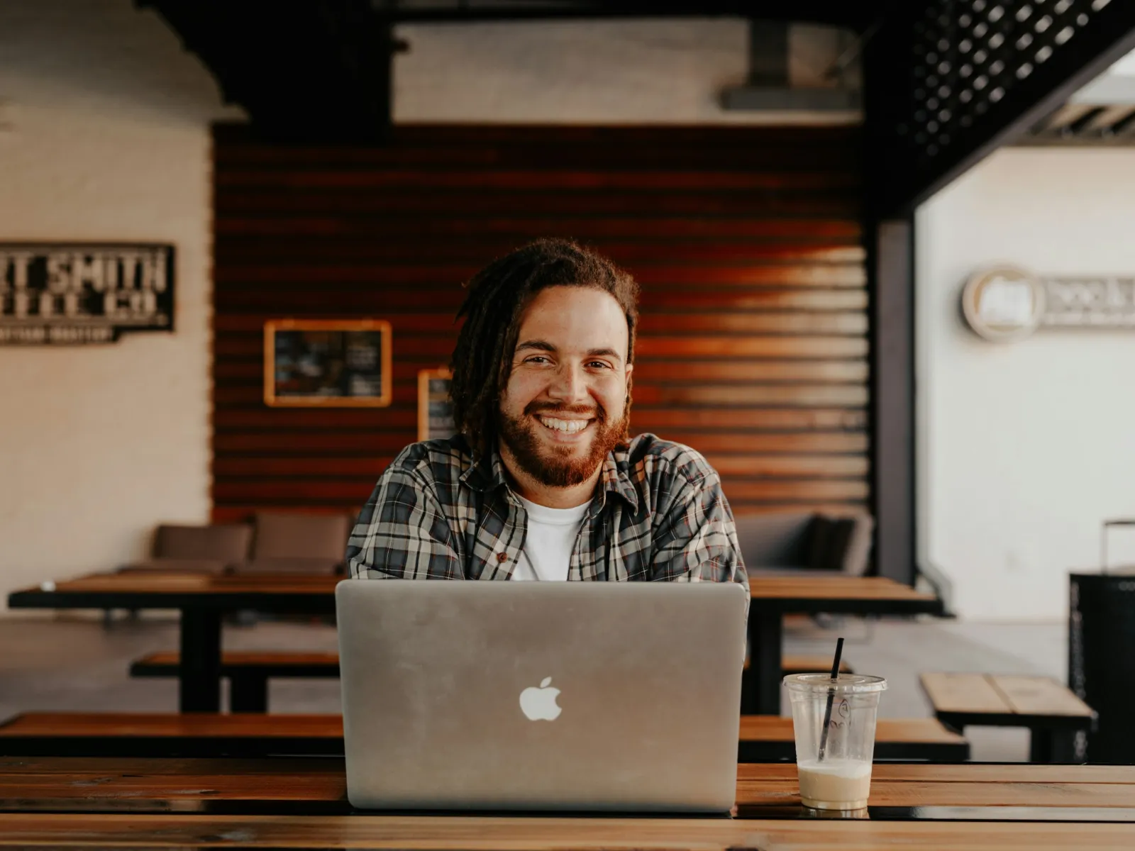 a person sitting at a table with a laptop