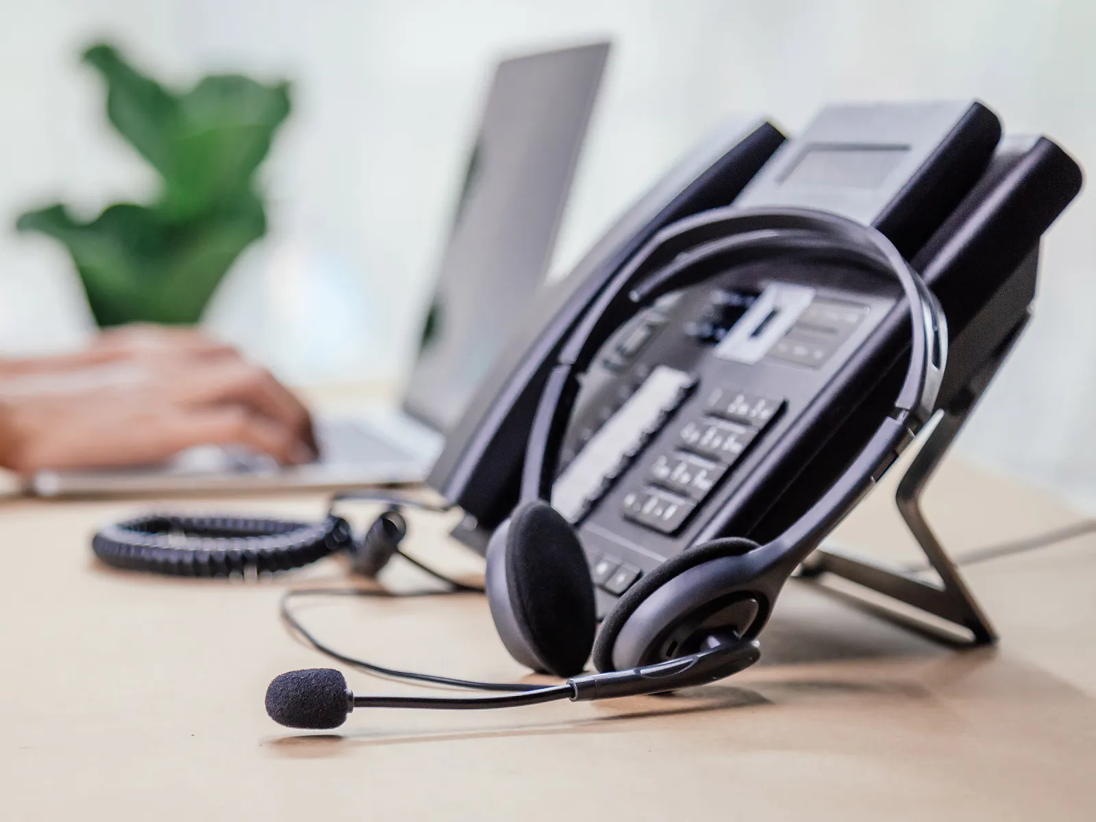 a hand holding a telephone