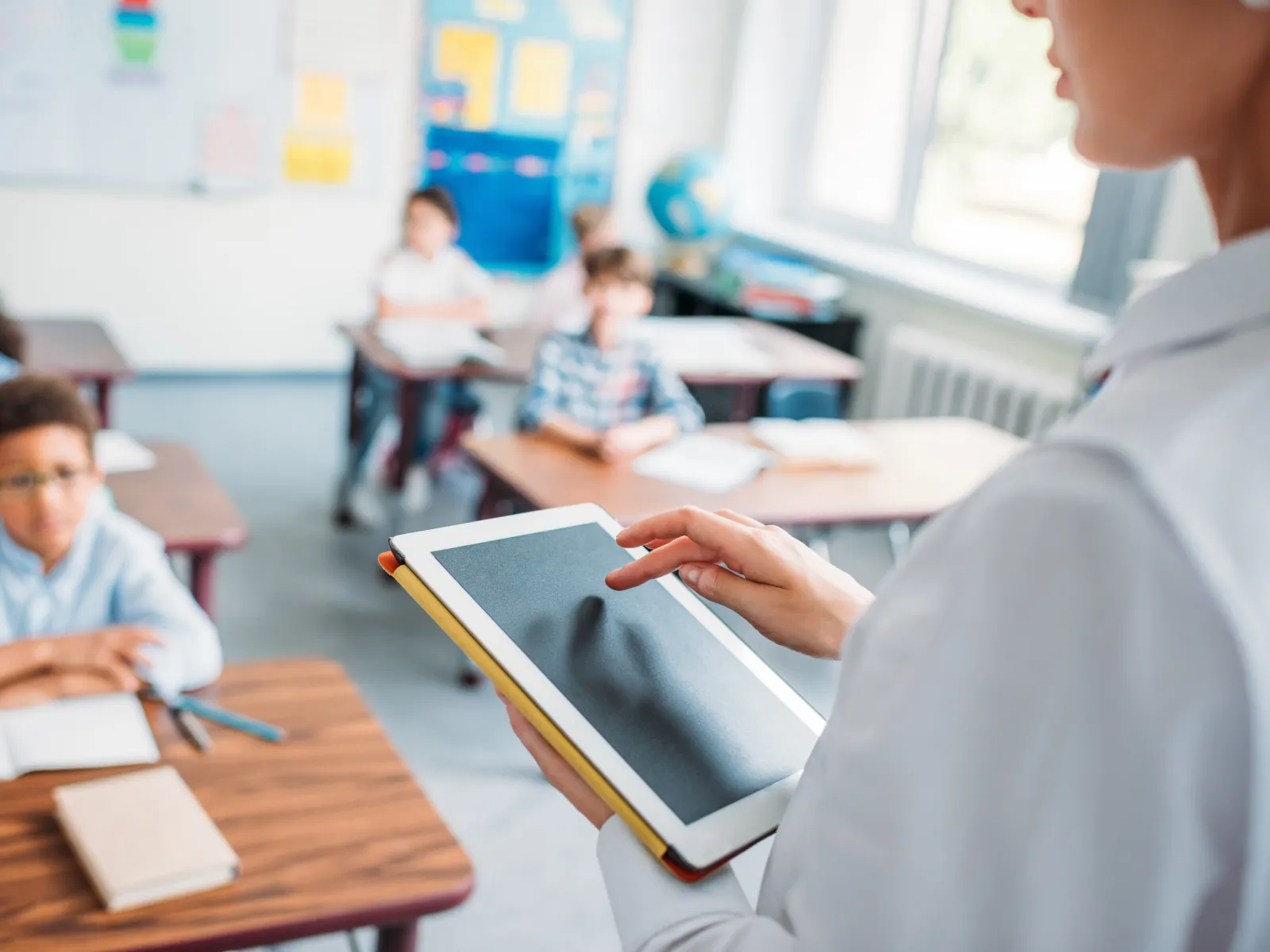 a person sitting at a desk in a classroom