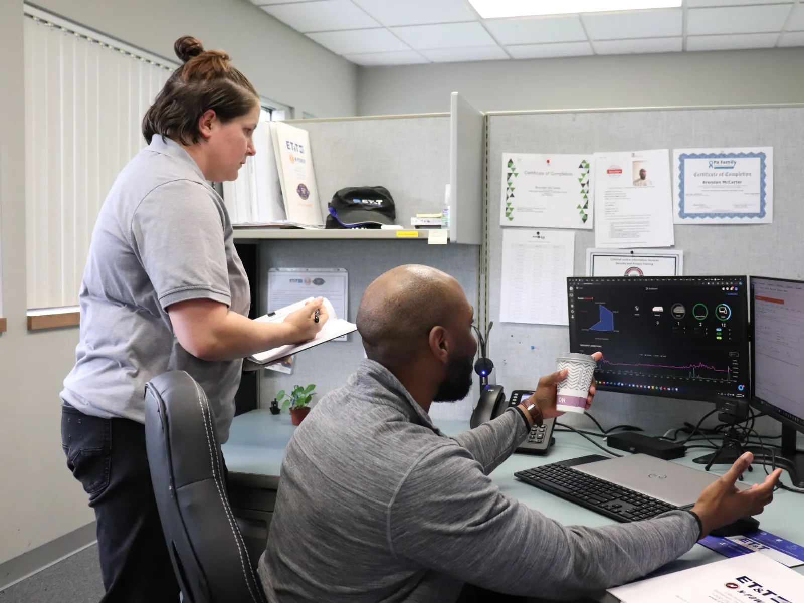 a man and a woman looking at a computer screen