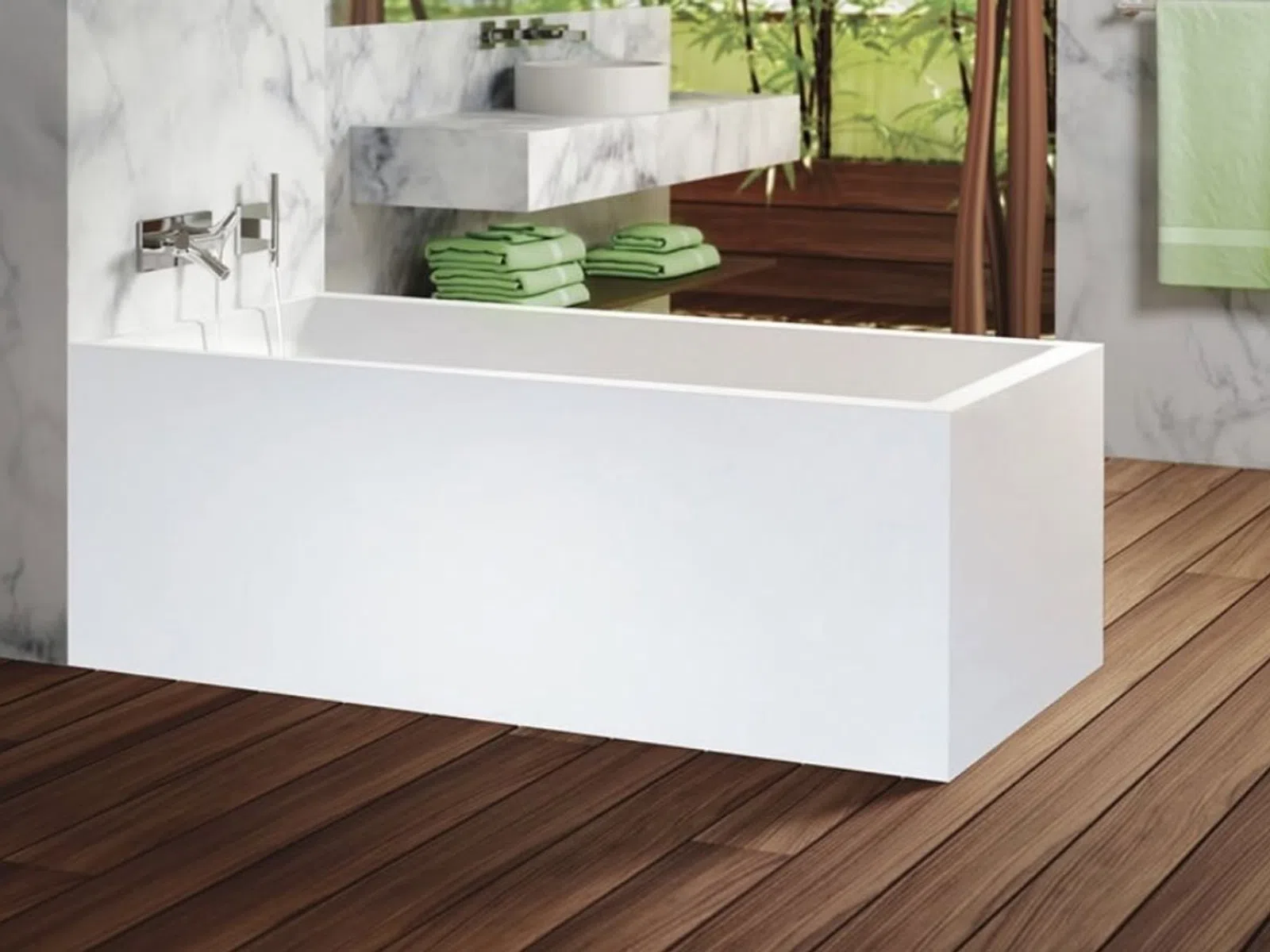 Modern white bathtub on wooden floor with green towels and marble walls in a bright bathroom