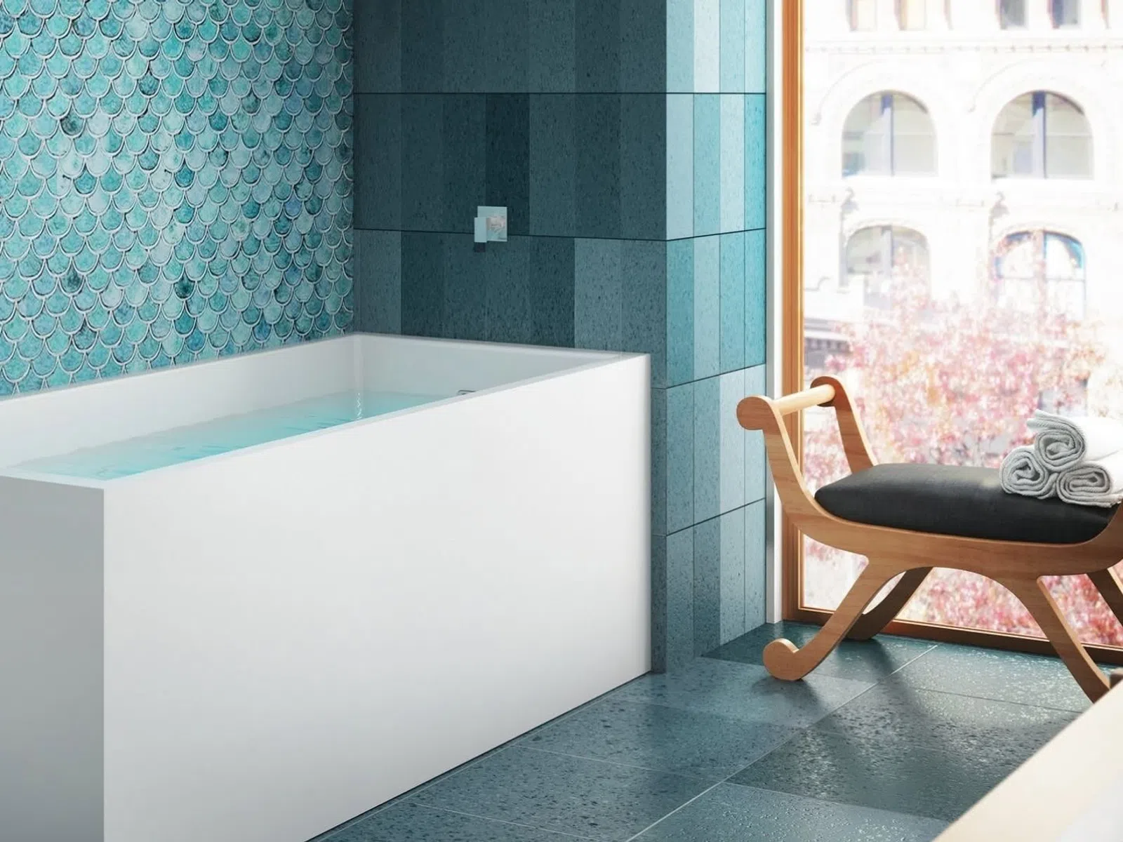 Modern bathroom with a white bathtub, blue tiled walls, and a wooden chair by a large window.