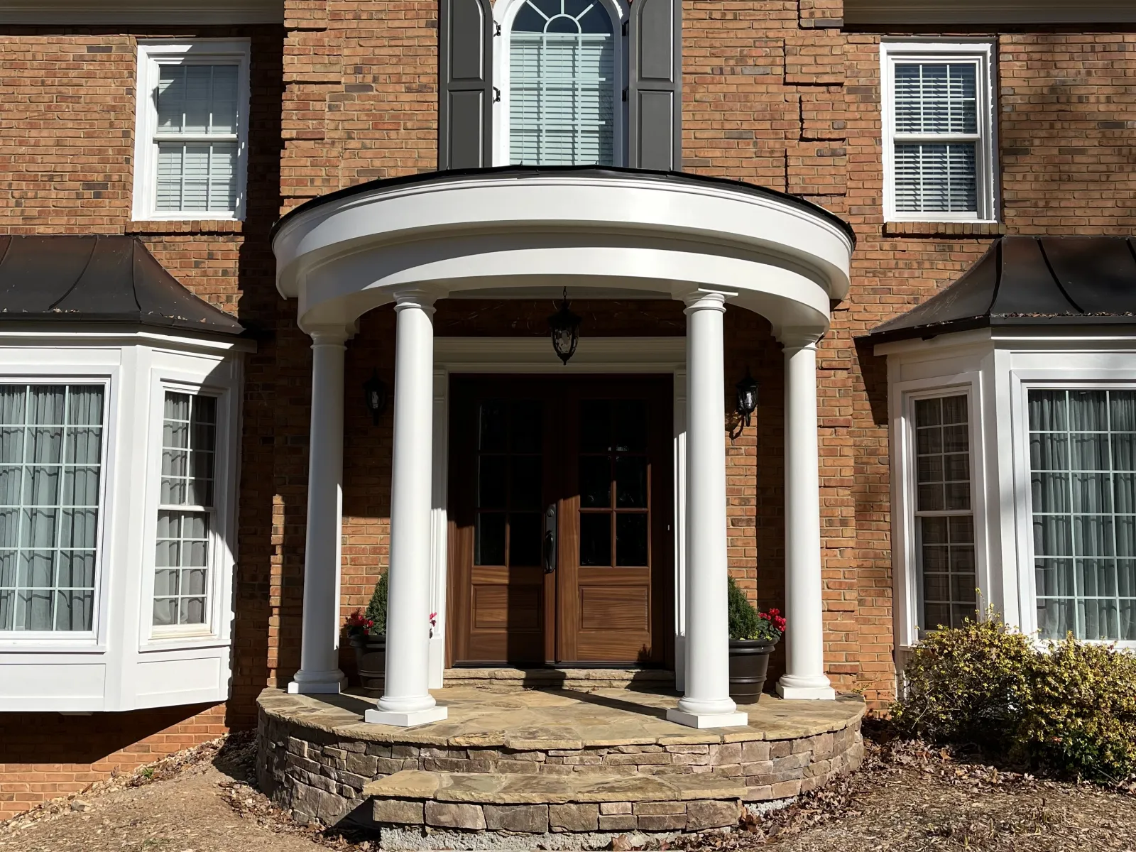 a brick house with pillars