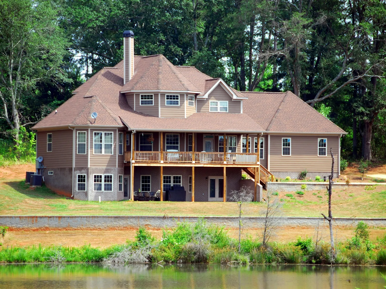 a house with a pond in front of it