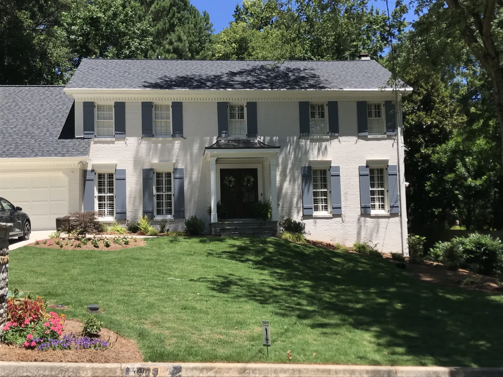 a white house with a green lawn