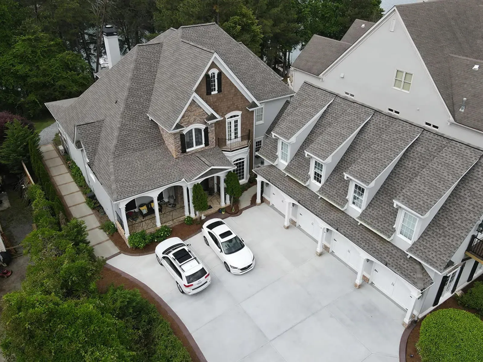 a street with cars parked on it and houses around it