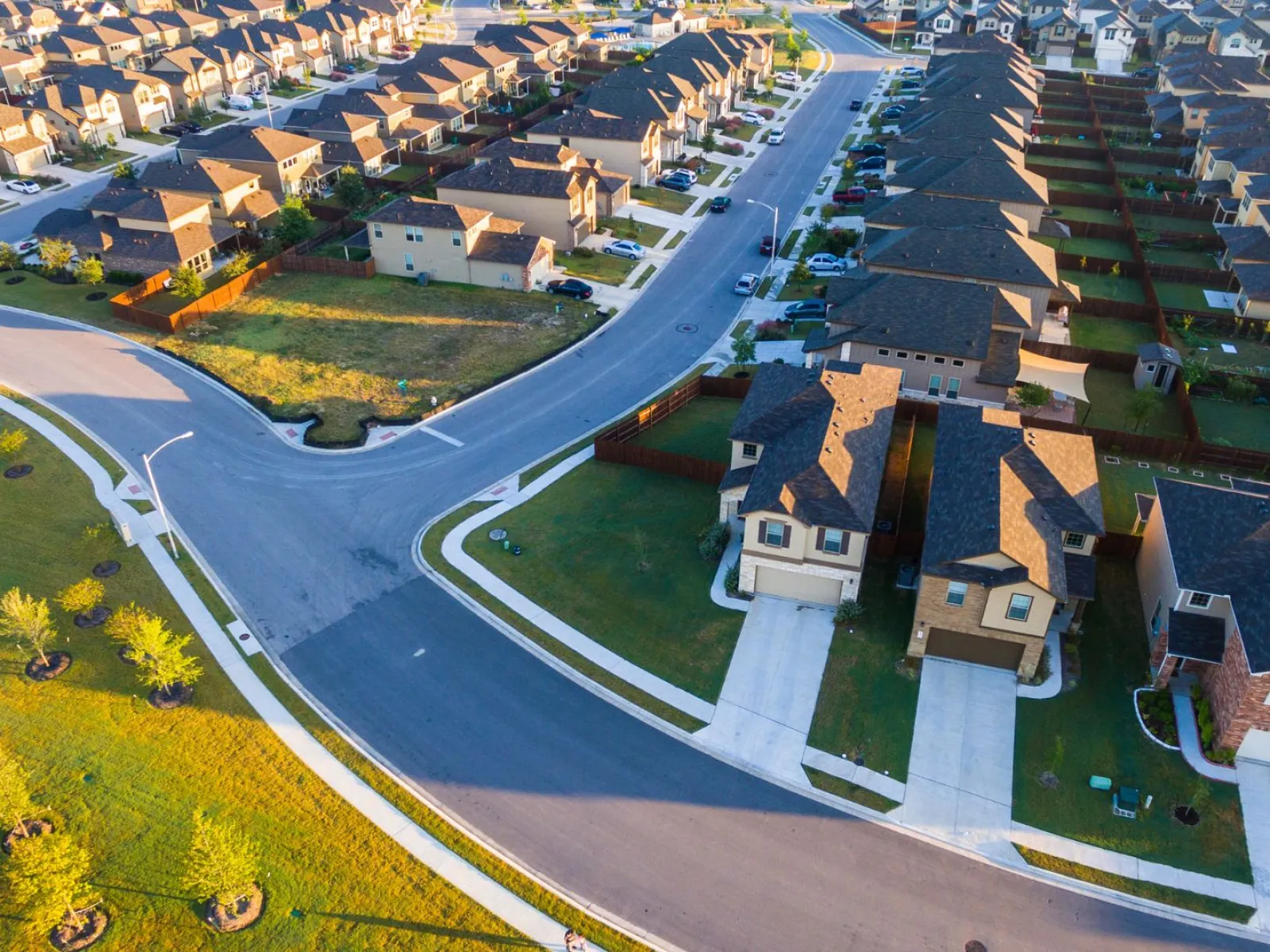 Aerial view of a suburban neighborhood with winding roads and neatly arranged houses.