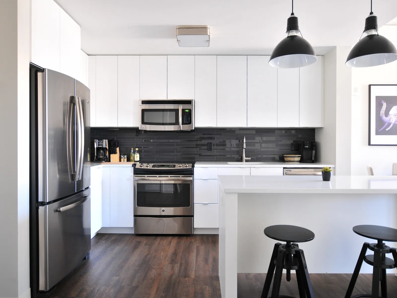 a kitchen with a bar stool and a refrigerator