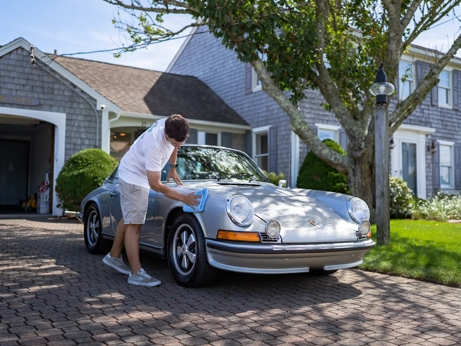 Sleek red sports car glistening with raindrops, showcasing modern design and powerful rear features.