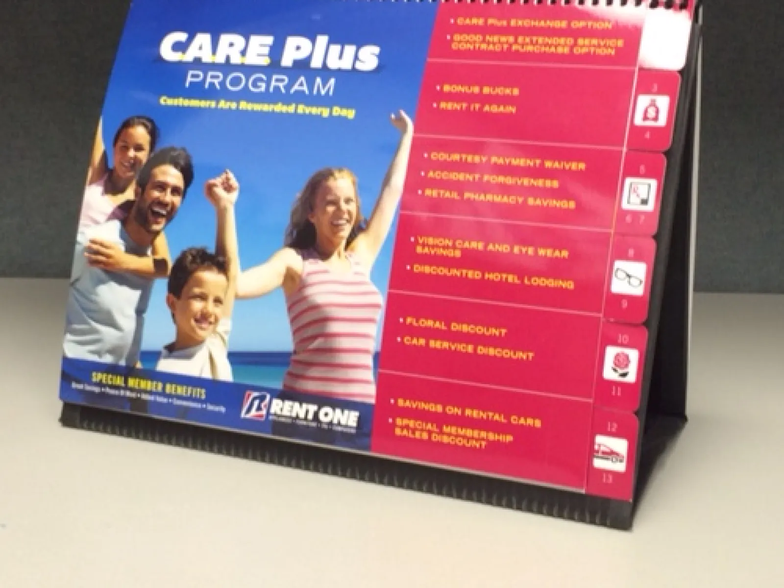 CARE Plus Program brochure with smiling family, member benefits, and Rent One logo on table.