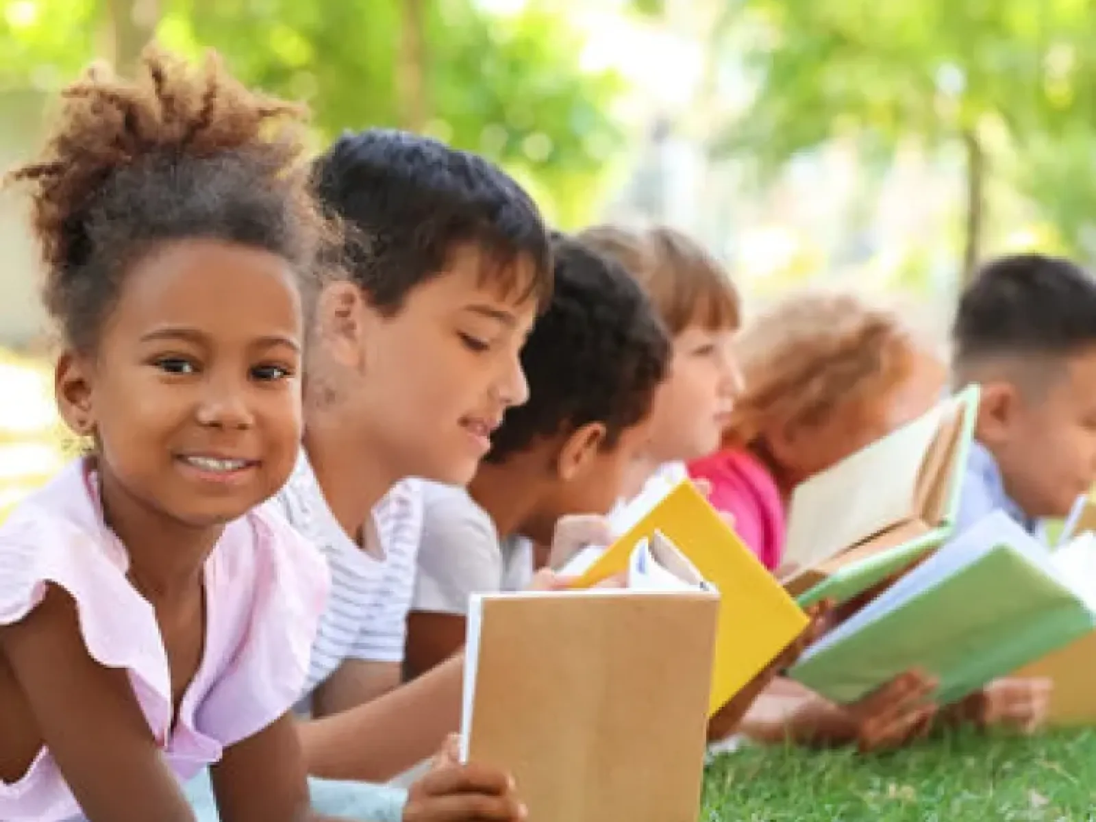 a group of children reading books