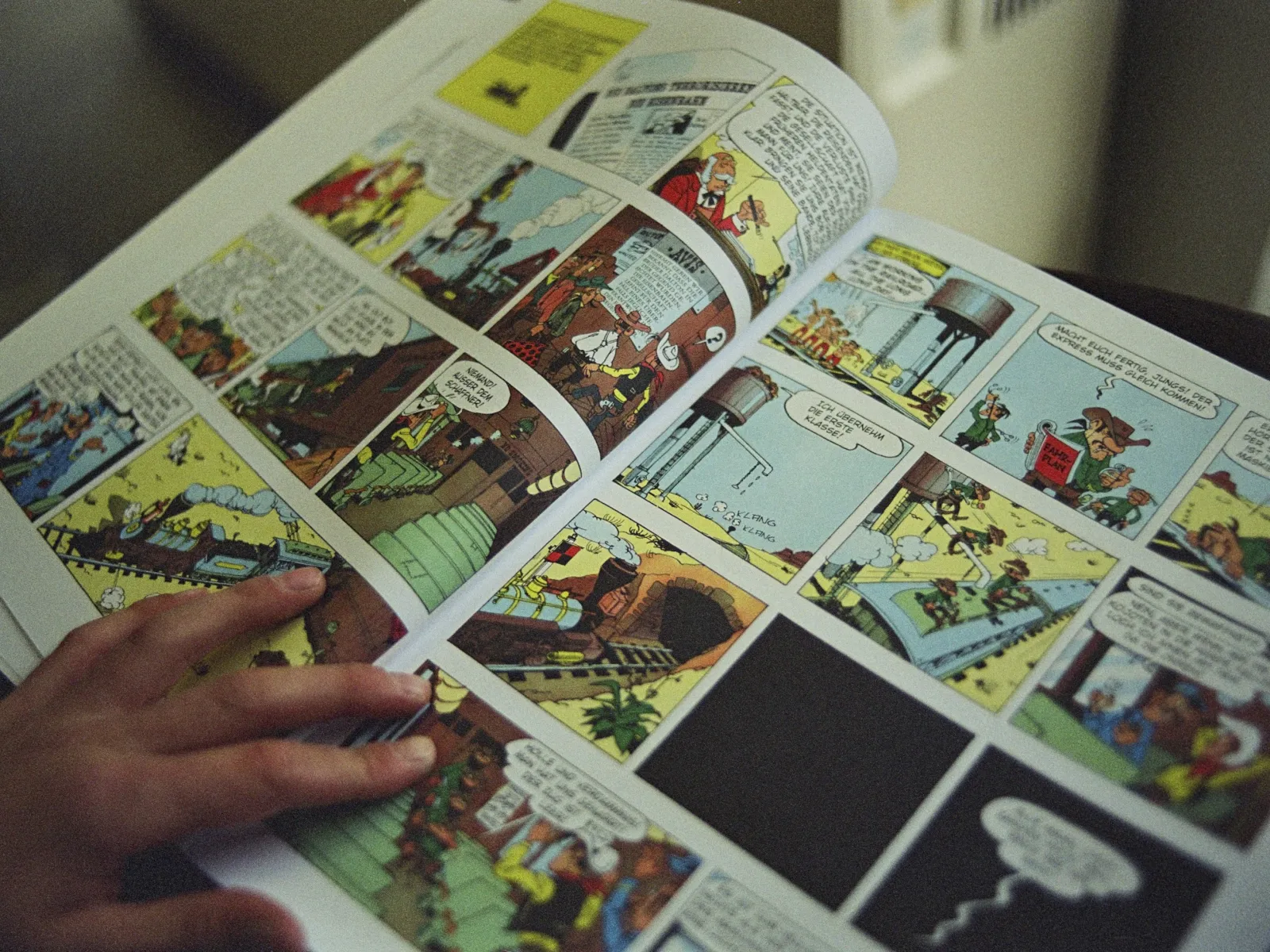 a hand holding a book