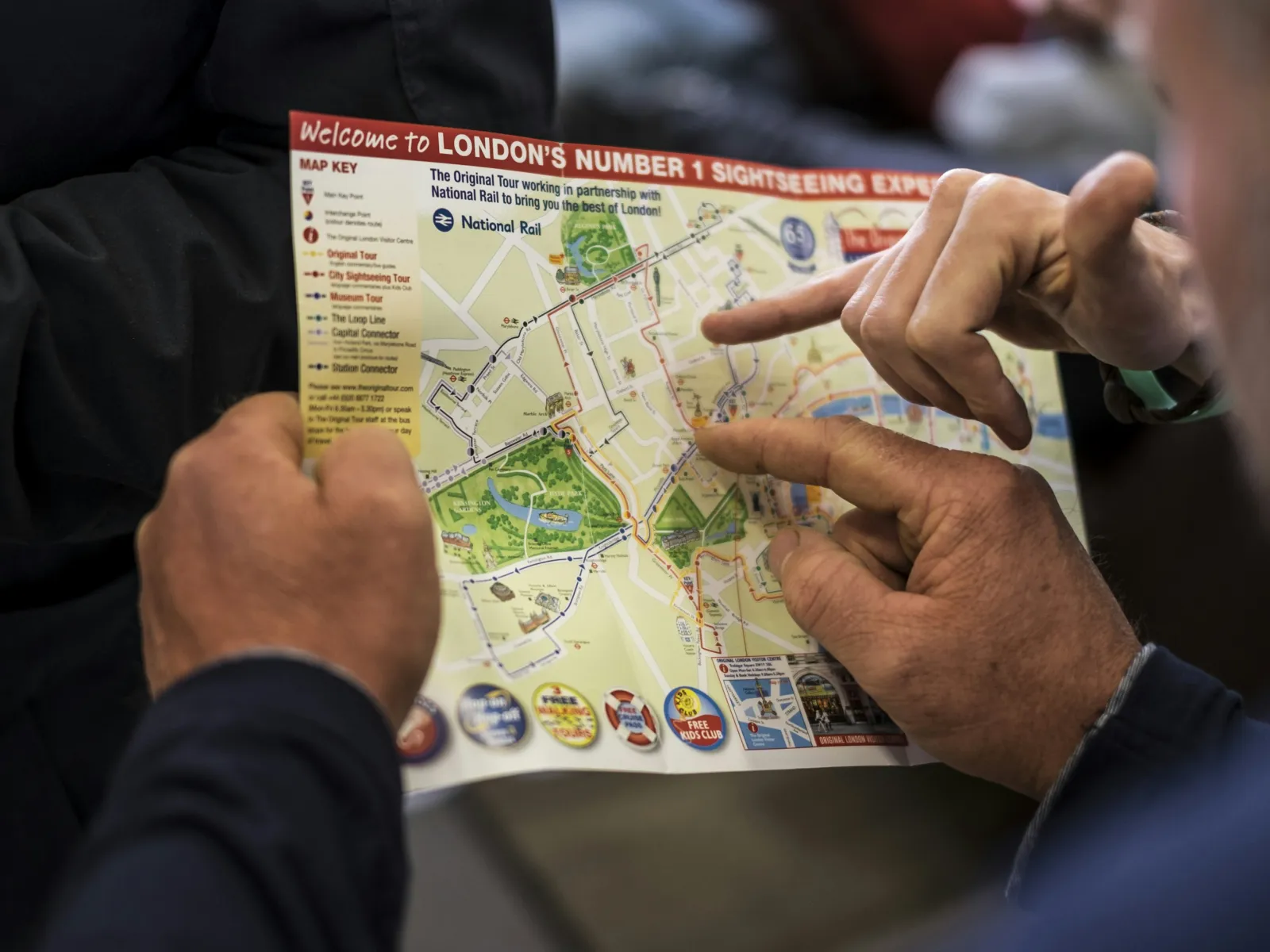 a few people pointing at a map