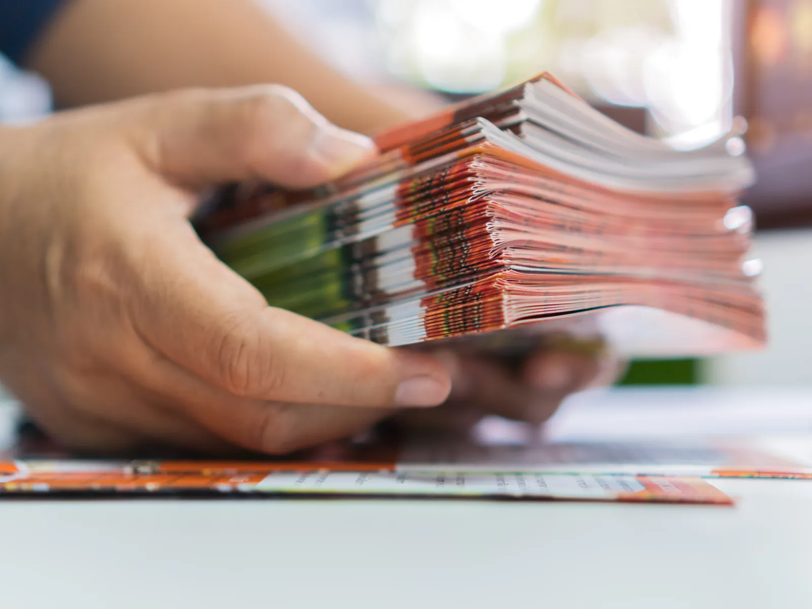 a close-up of a person holding a stack of money