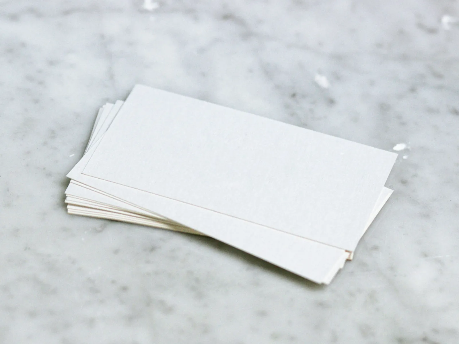 a white piece of paper on a grey surface