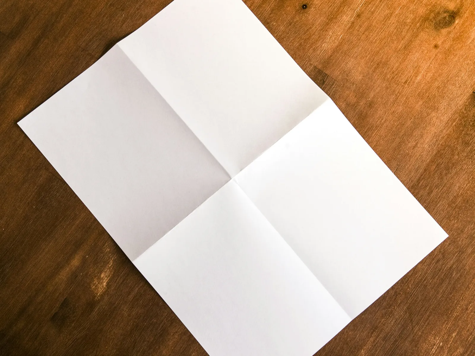 a white piece of paper on a wooden surface